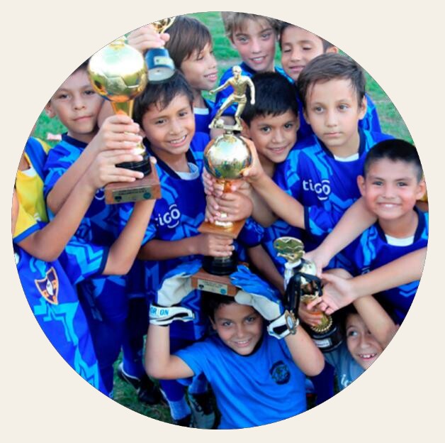 Jugadores jóvenes de El Semillero con trofeos
